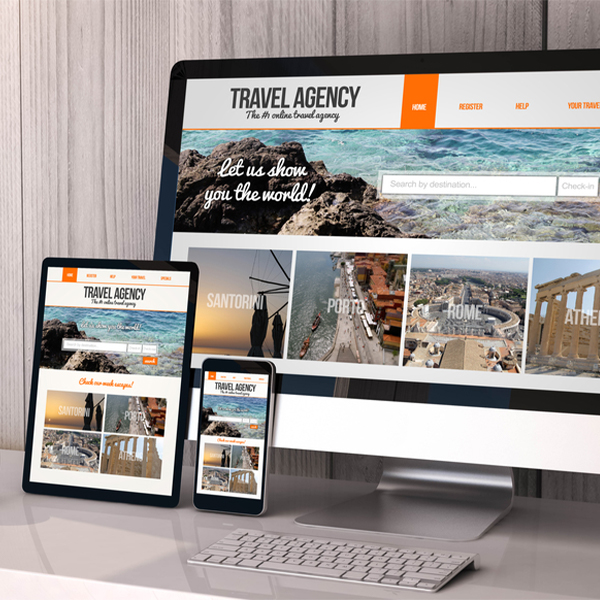 Travel agency website design samples on desktop, tablet, and smartphone.