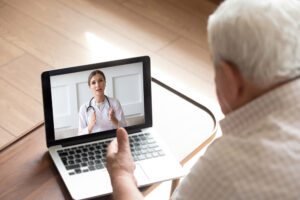 Elderly man visiting a doctor online