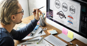 Man designing logos on his iMac