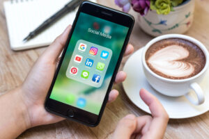 cell phone social media app menu with latte