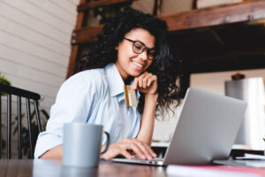 young woman on laptop smiling