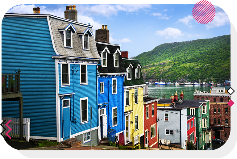 Colourful houses with the ocean and a mountain in the background