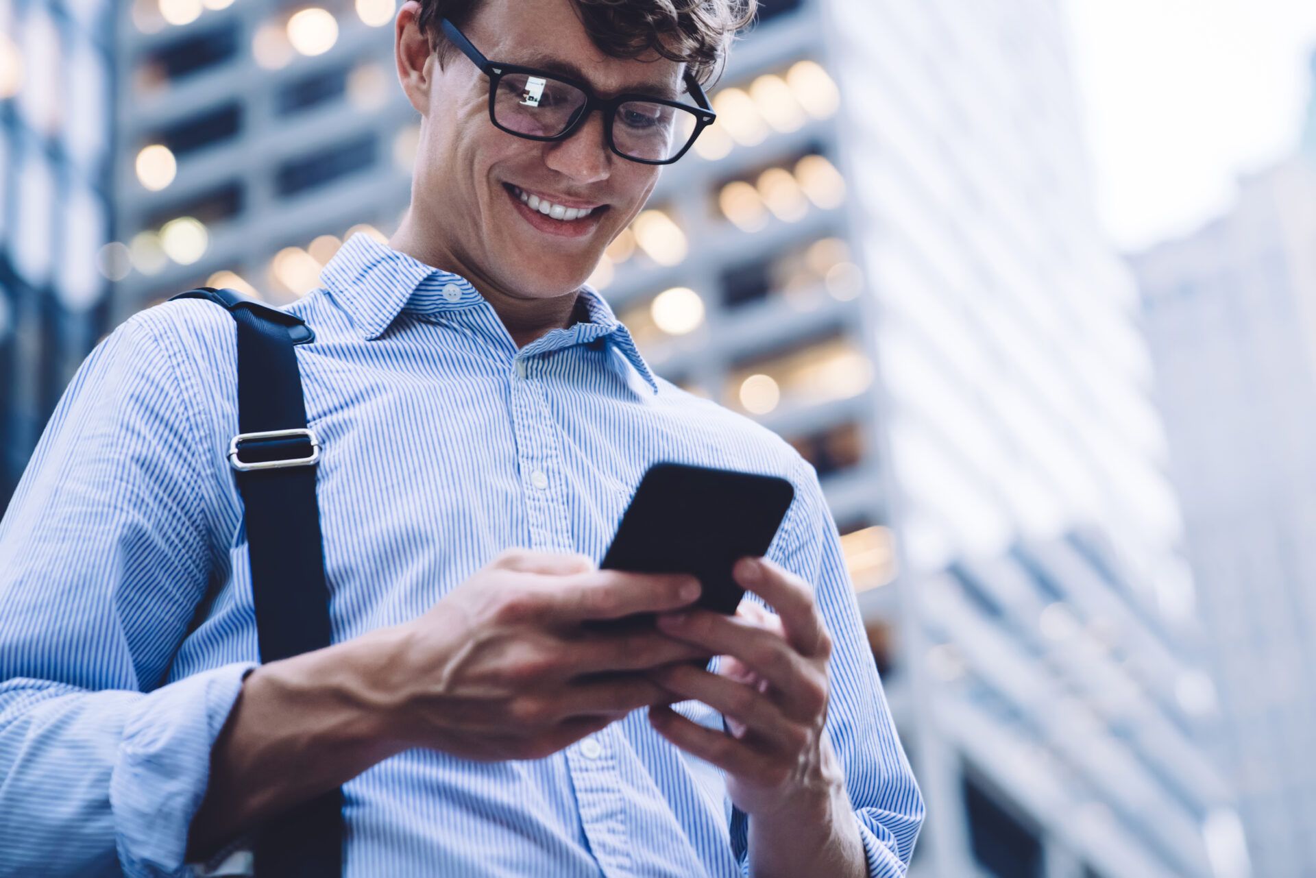 happy man searching web on phone