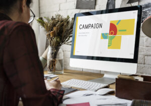 Person looking at computer with a campaign image on it